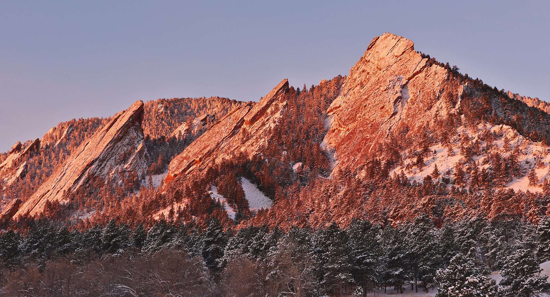 The Flatirons in winter alpenglow above Boulder