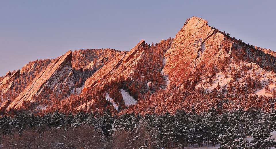 The Flatirons in winter alpenglow above Boulder