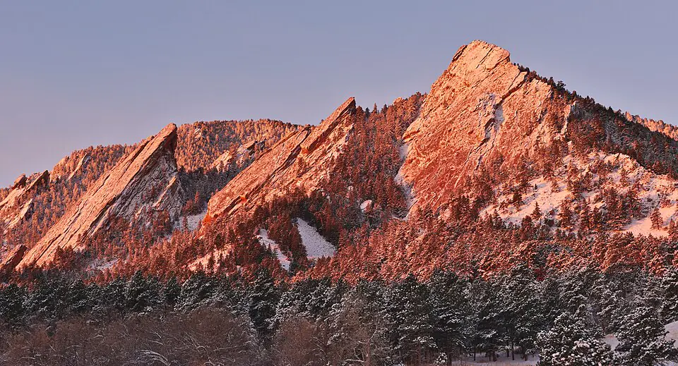 The Flatirons in winter alpenglow above Boulder